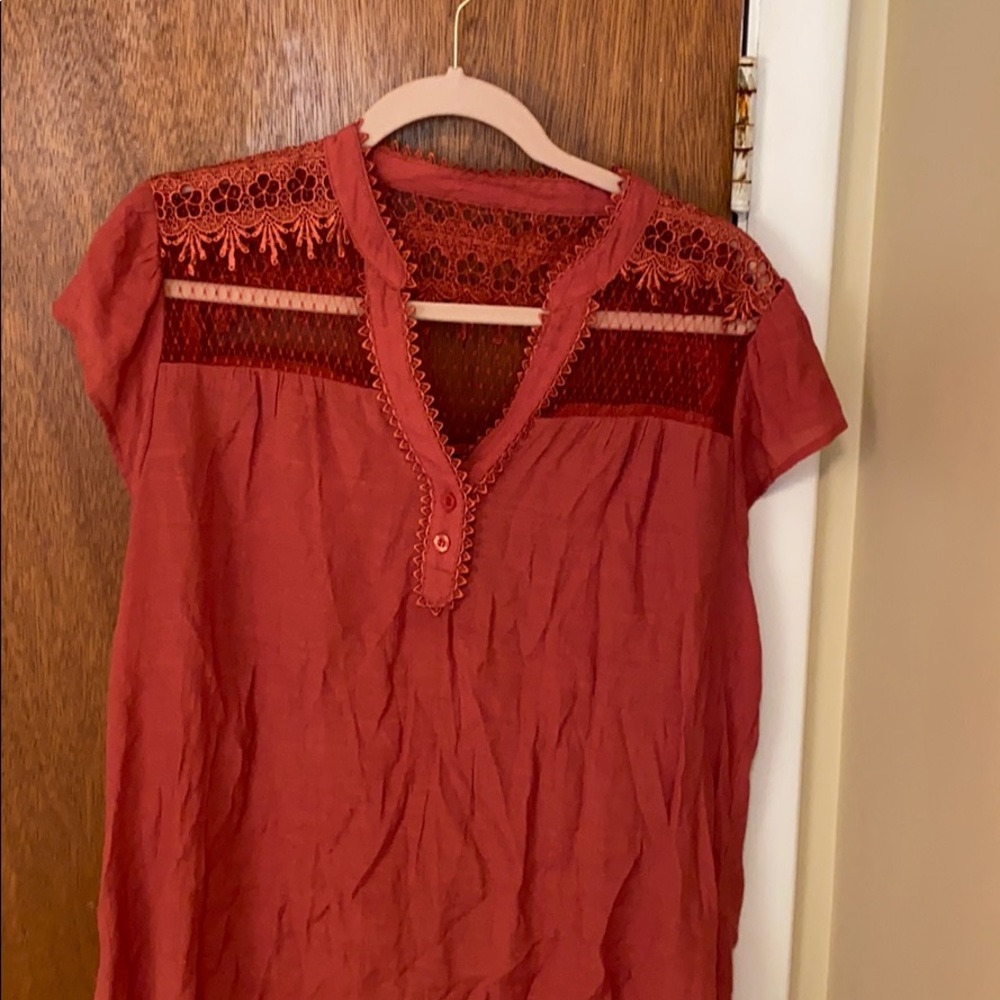 Rust/orange blouse with lace cutout shoulders